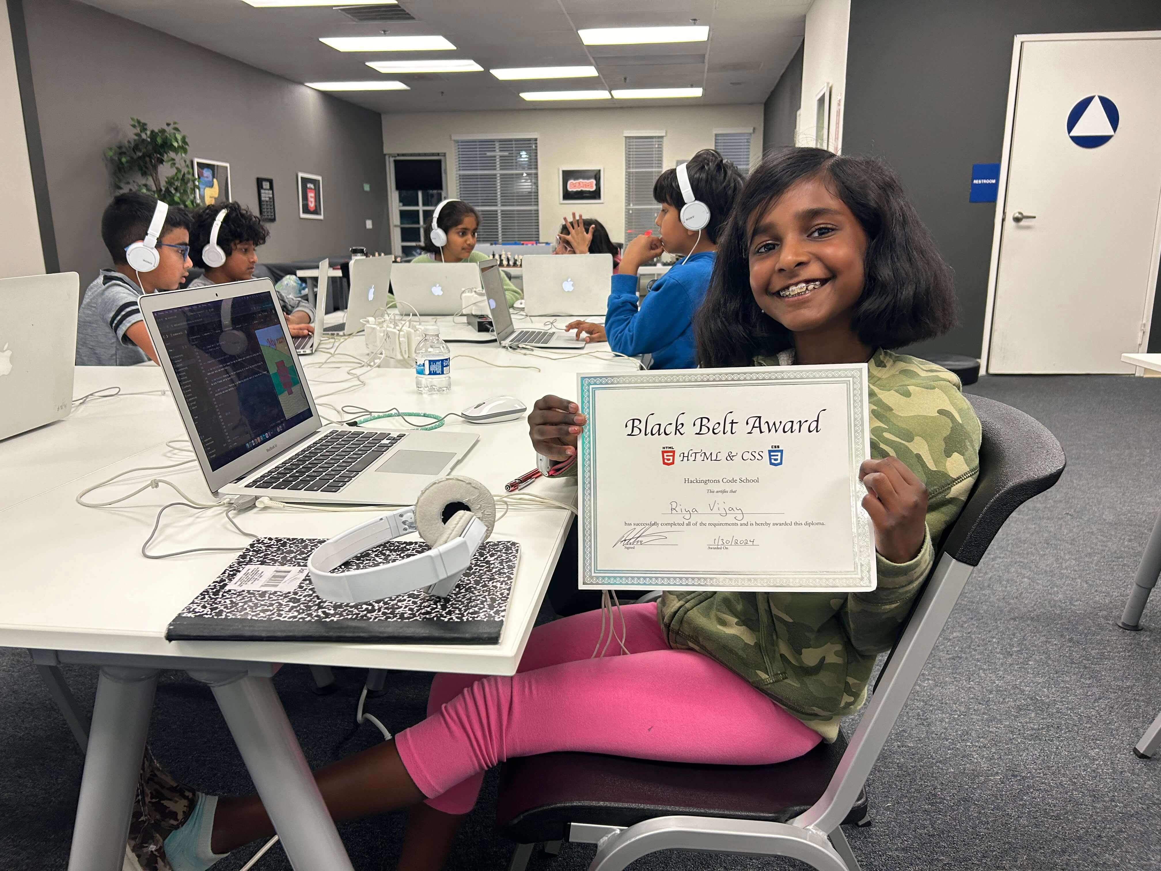 girl holding her black belt certificate award