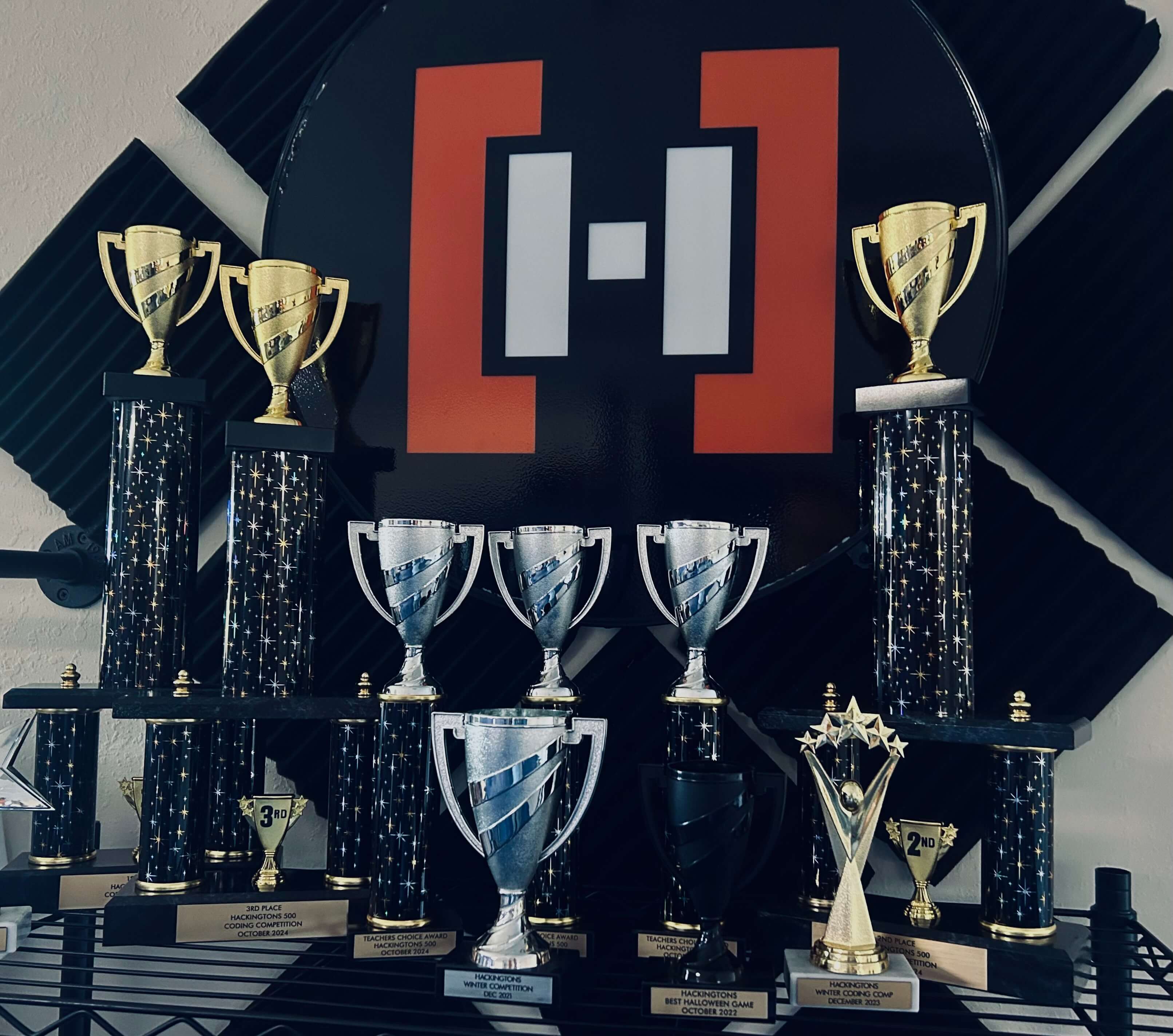 Hackingtons sign behind a group of trophies about to be handed out to competition winners